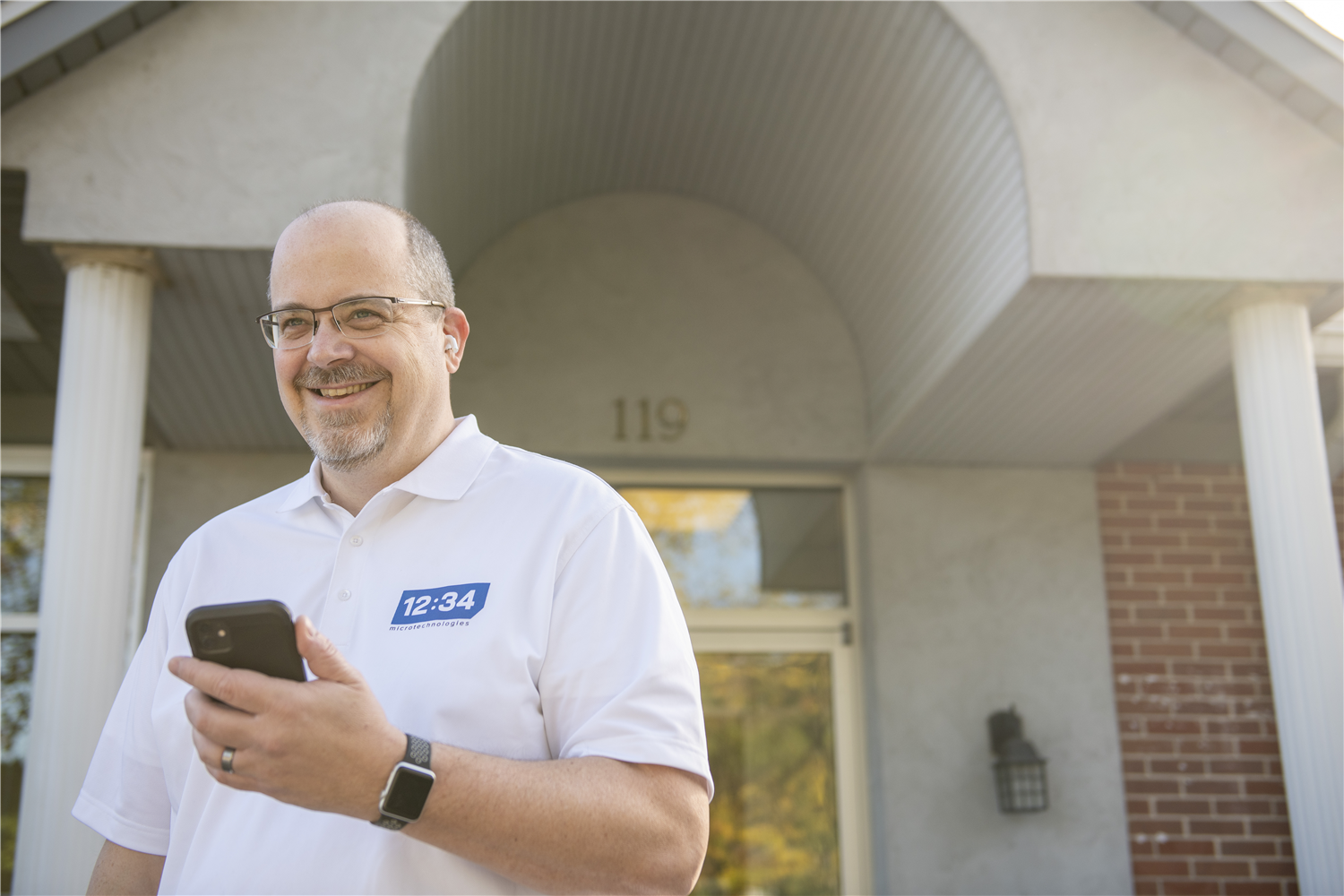 Employee standing in front of the office